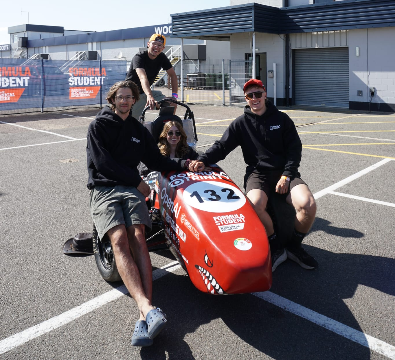 Team members with the Formula Trinity car
